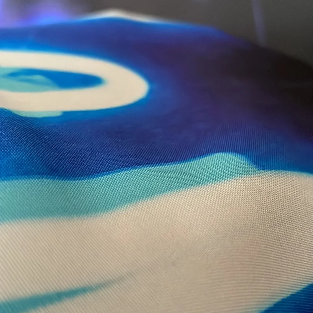 Black Tapestry with Blue Letters Graphic.